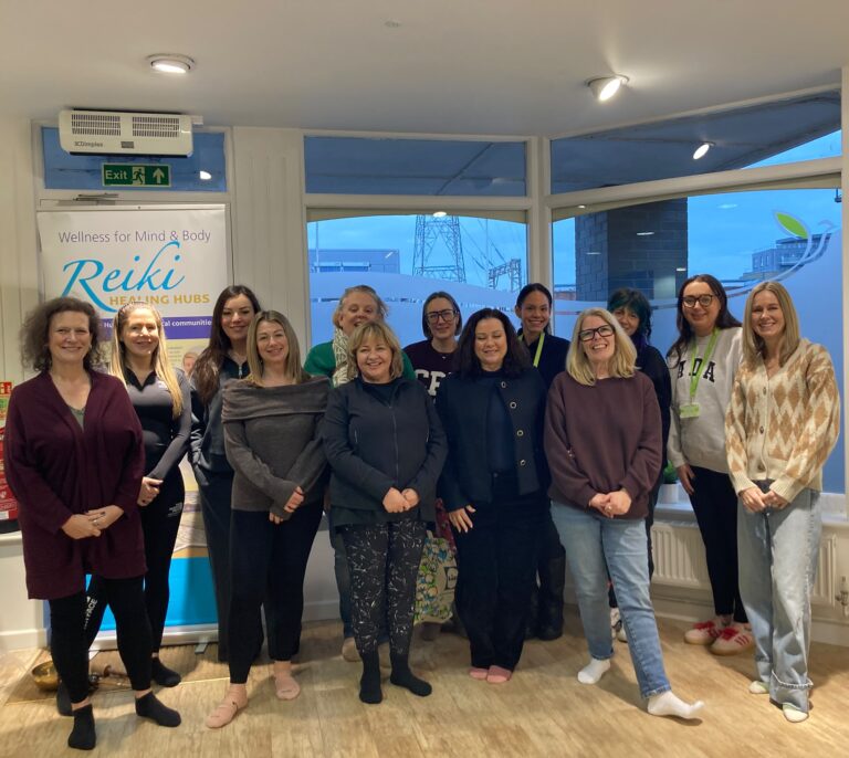 Employees participating in a group corporate well-being day in Colchester, Essex, featuring guided sound bath meditation and breathwork by JM Reiki.