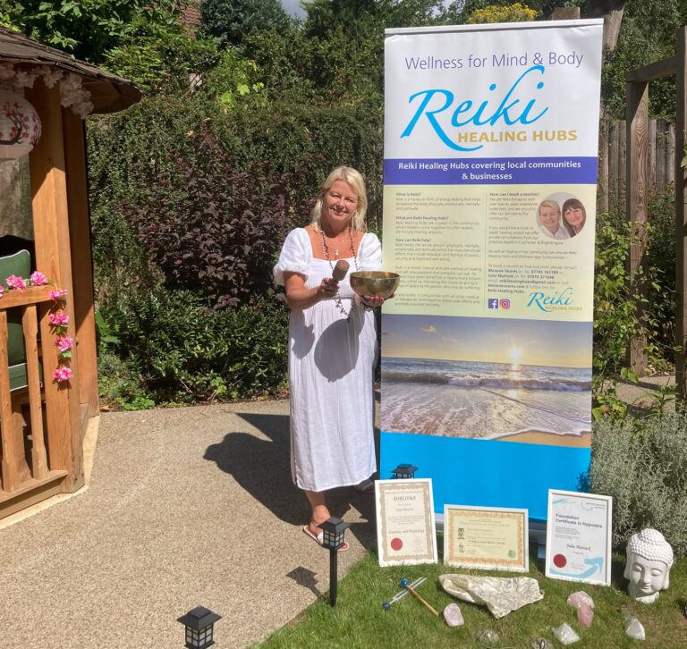 Qualified Reiki practitioner Julia Mattack holding a Tibetan singing bowl in her Colchester treatment room, offering professional sound healing therapy.